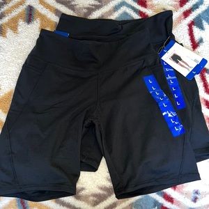 A set of two large, black bike shorts Danskin